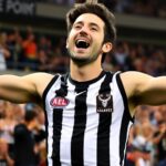 Nick Daicos celebrating in Collingwood jersey during match.